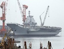 CHINA'S refitted aircraft carrier will begin serving in the navy officially this year, senior military officials said yesterday. Fighter jets will soon be involved in sea trials that have been running smoothly so far, Xu Hongmeng, deputy commander of Chinese navy, said.