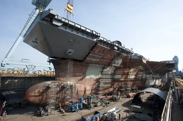 The flight deck of the nuclear-powered aircraft carrier Pre-Commissioning Unit (PCU) Gerald R. Ford (CVN 78) is completed with the addition of the upper bow. The bow weighs 787 metric tons and brings Gerald R. Ford to 96 percent structural completion. (U.S. Navy photo courtesy of Huntington Ingalls Industries, Inc./Released) 