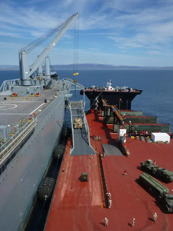 Following its offload from the LCAC, an M88 ARV transits on the Raised Vehicle Deck (RVD) and up the VTR to be transferred onto Bob Hope. An ITV-PM, a M970 Refueling system, and a Logistic Vehicle System Replacement (LVSR) Wrecker prepare to transit following the ARV.