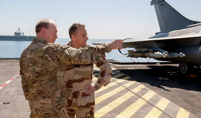 US General Martin Dempsey, Chairman of the Joint Chiefs of Staff , with his French counterpart General Pierre de Villiers on-board the Charles de Gaulle. Note USS Carl Vinson in the background. French Navy Picture