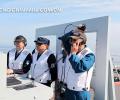 The picture taken on June 19 shows that three landing commanders are commanding the ship-borne J-15 fighters to land on the deck of the “Liaoning Ship”. (Chinamil.com.cn/Li Tang)