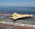 The picture taken on June19 shows that a ship-borne J-15 fighter is successfully landing on the deck of the “Liaoning Ship” with the help of arresting cable. (Chinamil.com.cn/ Li Tang)